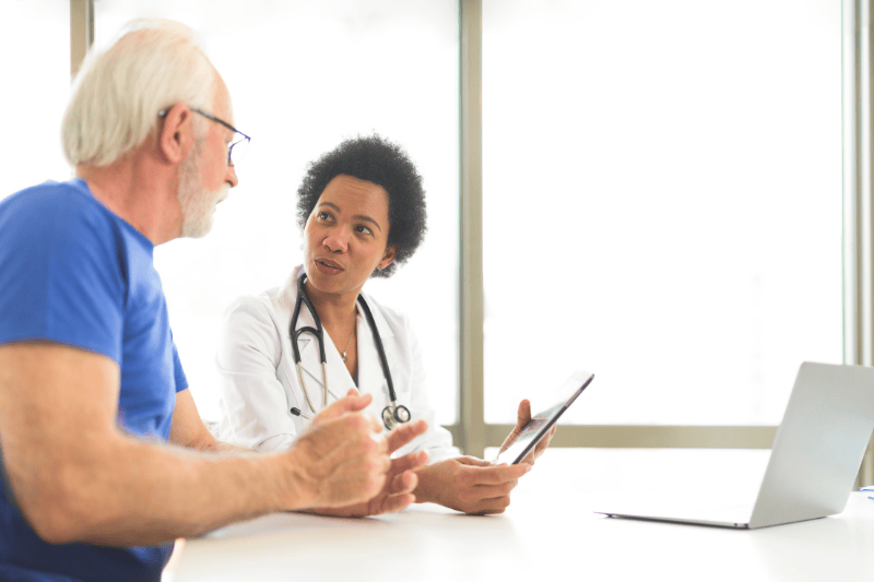 Man talking with doctor.