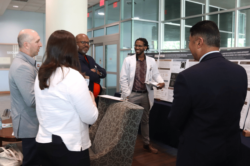 A resident presenting their research