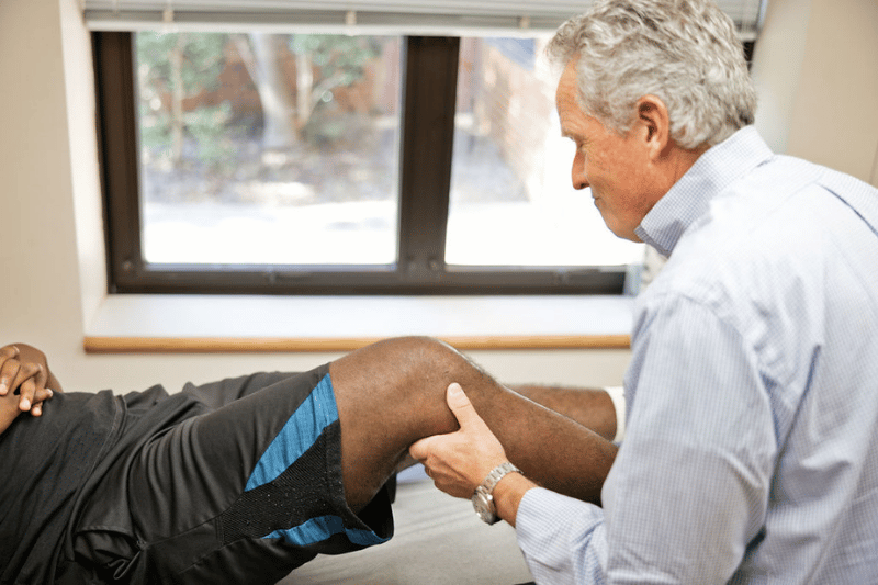 An orthopedic physician at East Alabama Health evaluates a patient.