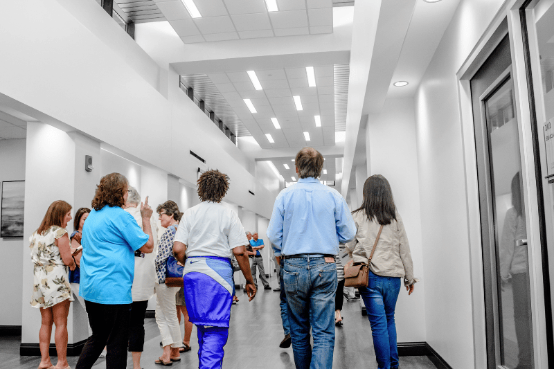 Visitors walking through the main atrium of the Spencer Cancer Center.