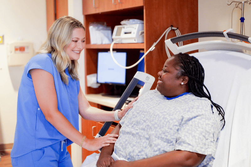 A nurse and mother in a patient room within the Mother Baby unit at EAMC.
