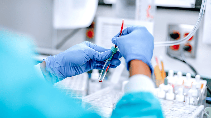 A researcher holding a test tube.