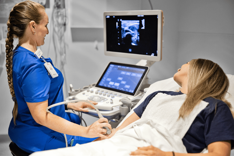 An ultrasound tech performing an ultrasound.