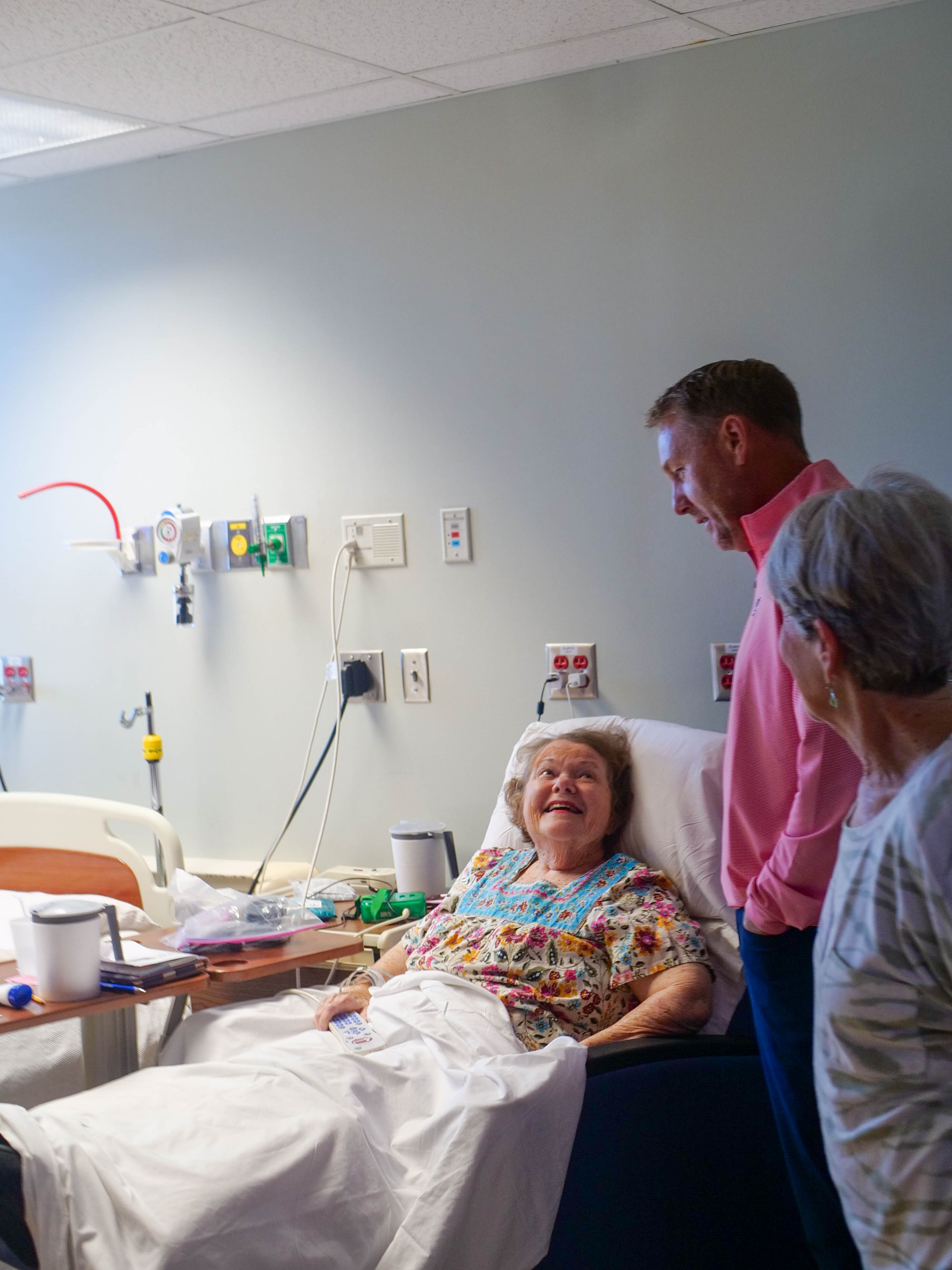 Hugh Freeze speaks with a patient while at EAMC.